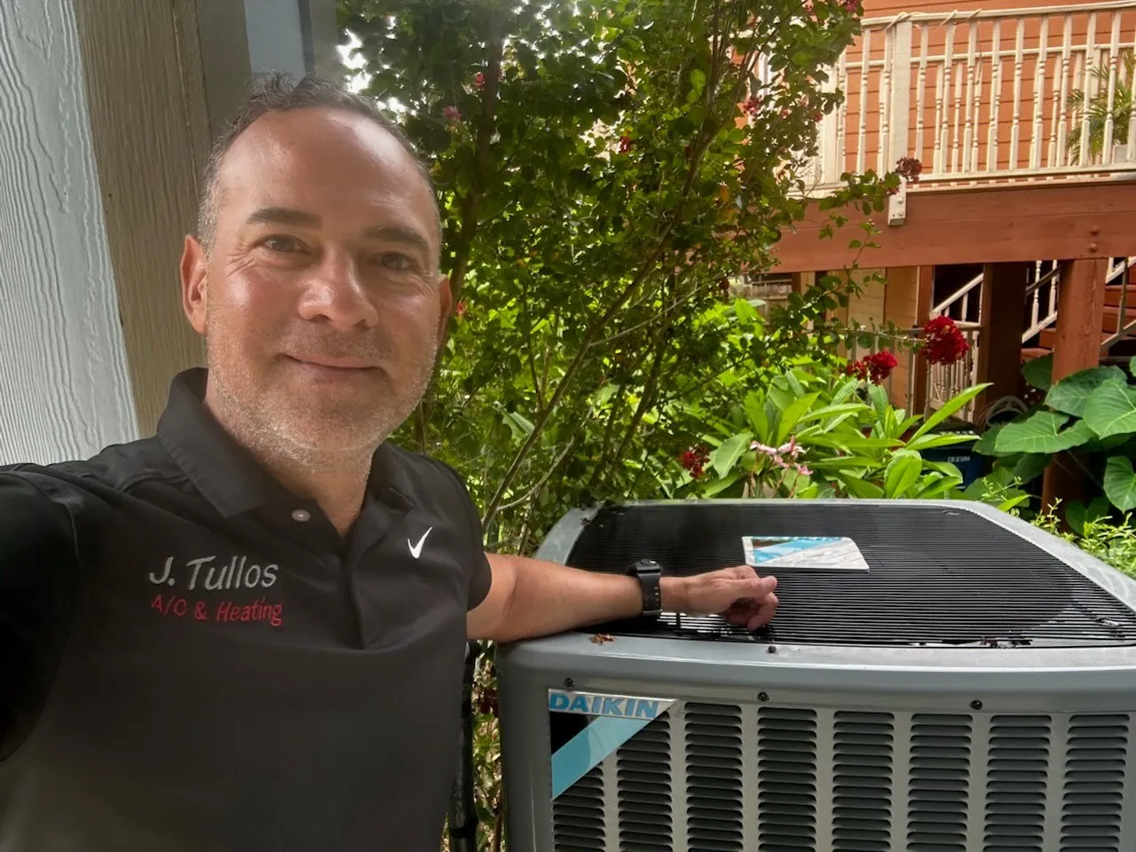 Jonathan Tullos of J. Tullos Services beside a Daikin outdoor AC unit