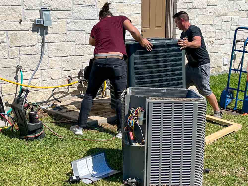 J. Tullos Services technicians installing a new air conditioning system