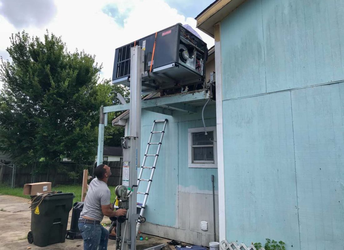 Expert J.Tullos Service technician performing meticulous air conditioner maintenance in Harris County home